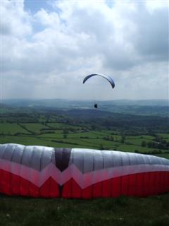 Andy W in the air and Simon Gant's wing on the ground at Corndon.